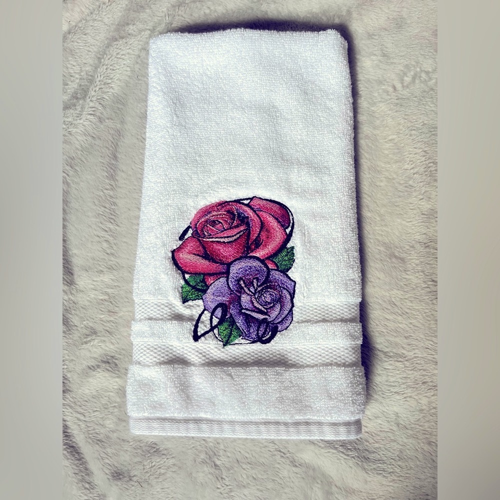 Floral handmade, machine embroidered hand towel featuring a pair of roses.